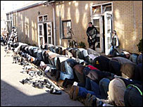 Muslims kneeling outside