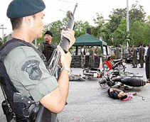Thai forces guard the bodies of slain Muslims